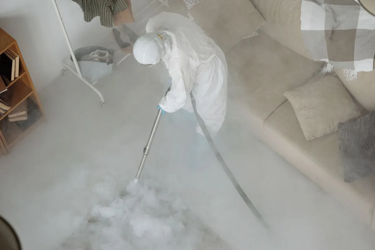 Biohazard cleanup technician in protective equipment, Iola, WI